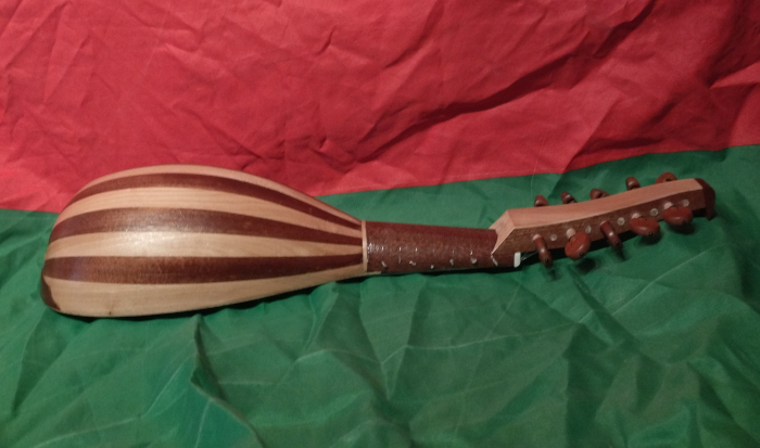 Side view of baroque mandolin with body of Sapele and European Elm.