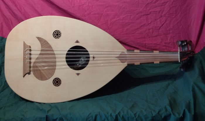 Front view of oud with alternative raqma (pickguard) and inlays.