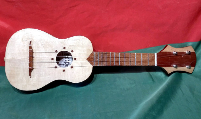 Front view of ukulele with alternative soundboard inlays and fingerboard of London Plane.