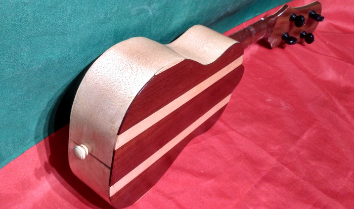 Back view from end of body of soprano ukulele with back of Sapele and Norway Maple, sides of Norway Maple and neck of Sapele.